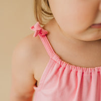Close up image of the bows on the Coral fowy bow strap tank