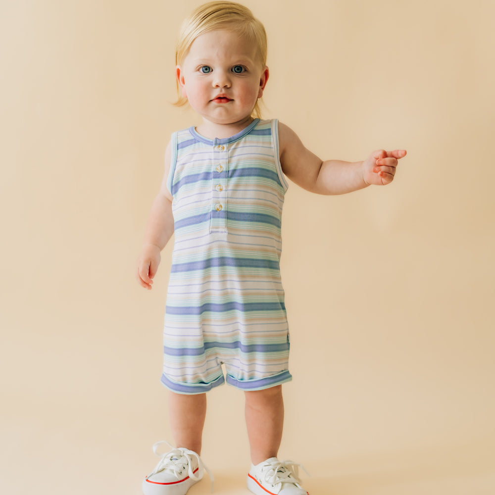 Child wearing a Surf Stripe tank button romper