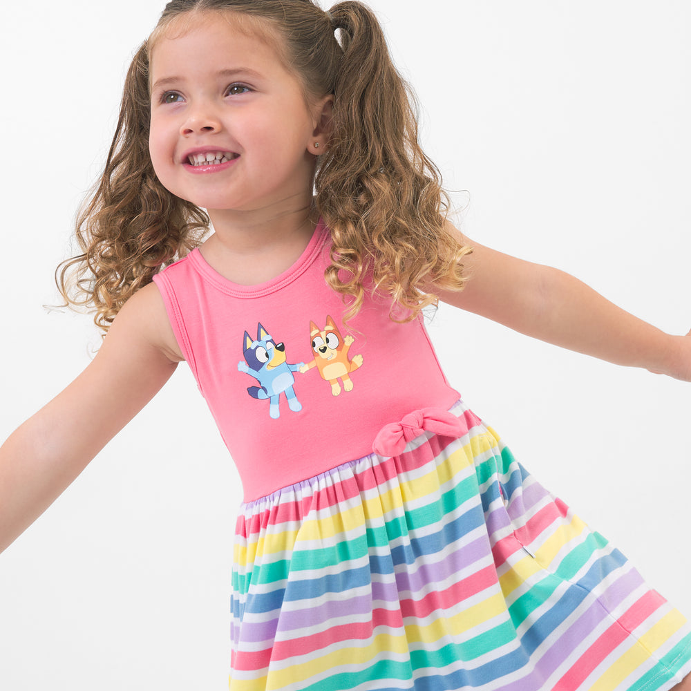 Close up image of a child wearing a Bluey graphic skater dress