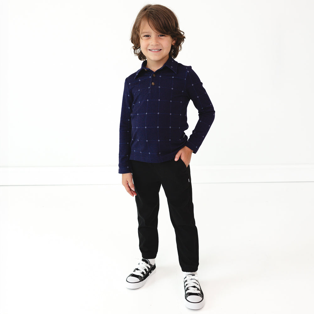 Child wearing Black Denim Joggers and coordinating Hanukkah Stars Plaid Polo Shirt