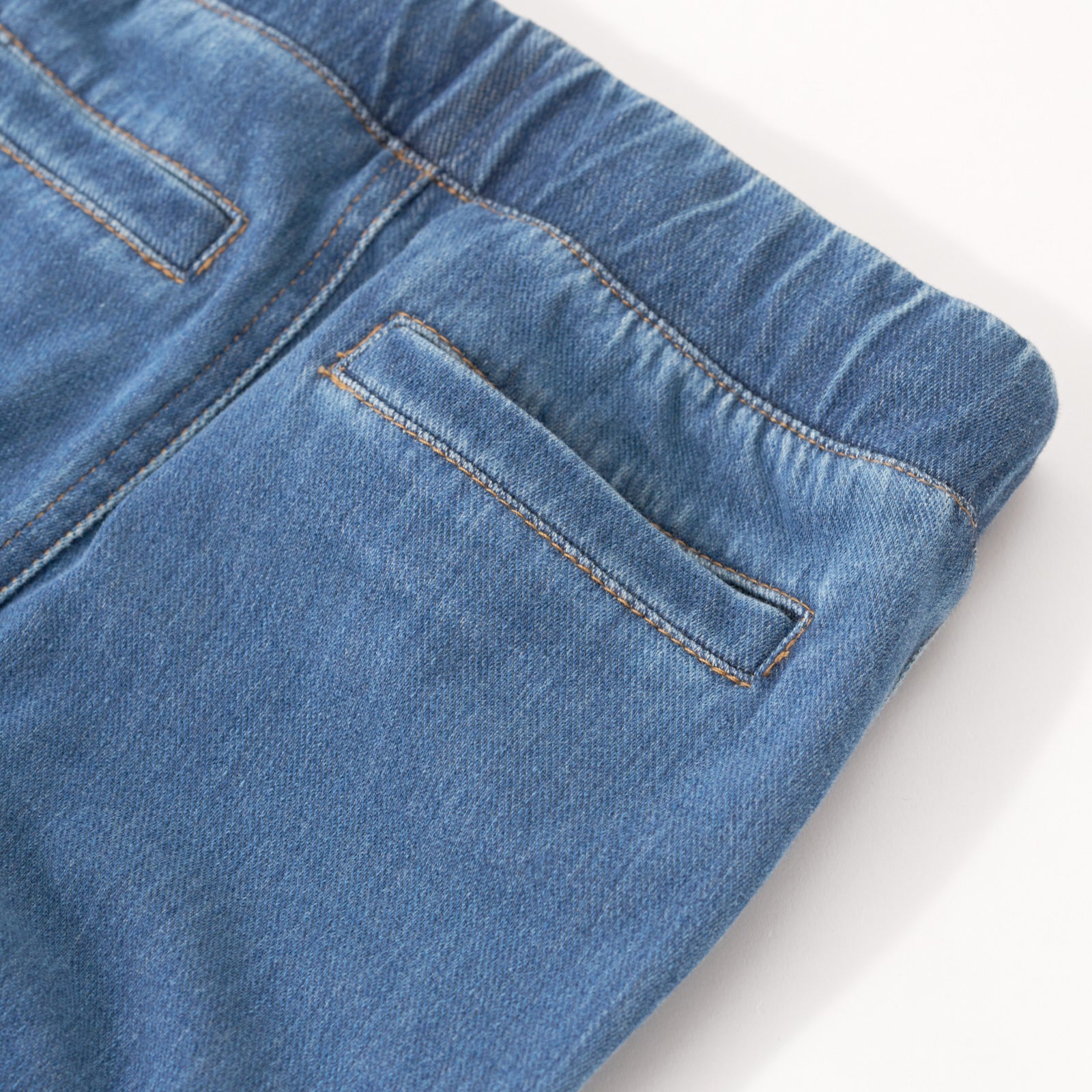 Close up image of the back pockets on the Midwash Denim Jogger