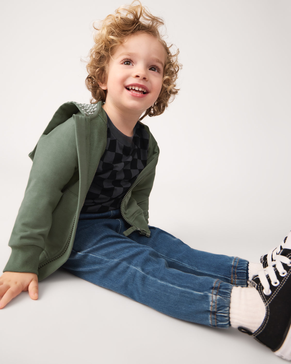 Boy wearing the Moss Zip Hoodie with denim joggers