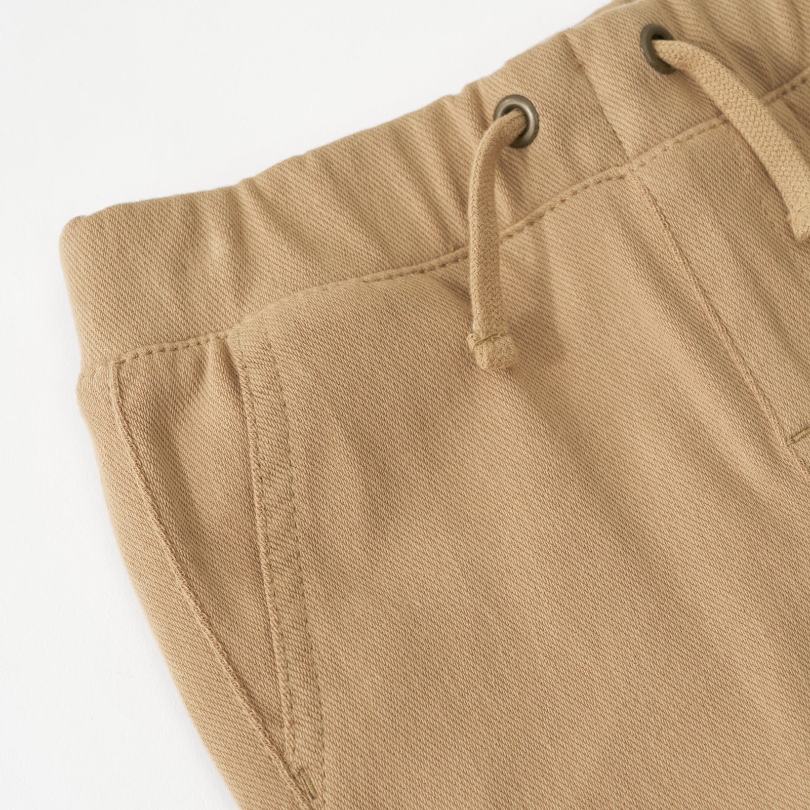 Close up flat lay image of the drawstring waist detail on the Toasted Hazelnut Denim Jogger