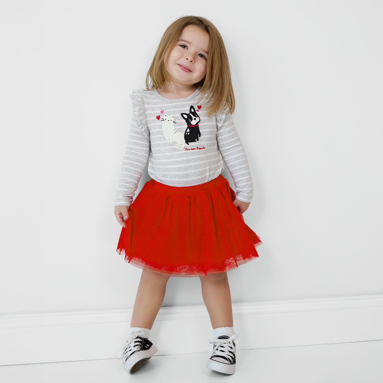 Child wearing a Candy Red Tutu Skirt and coordinating long sleeve Flutter Tee