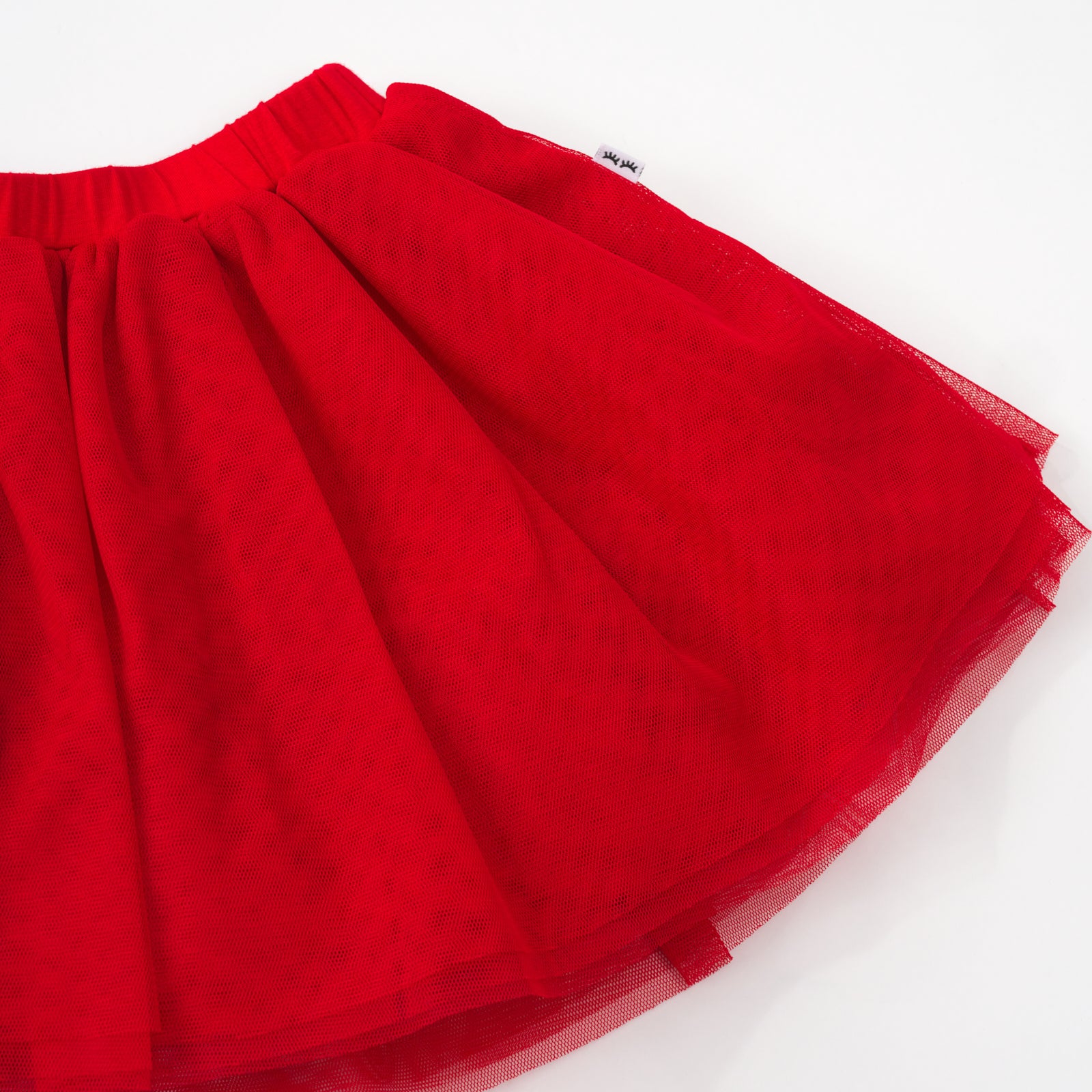 Close up flat lay of the candy red tutu skirt