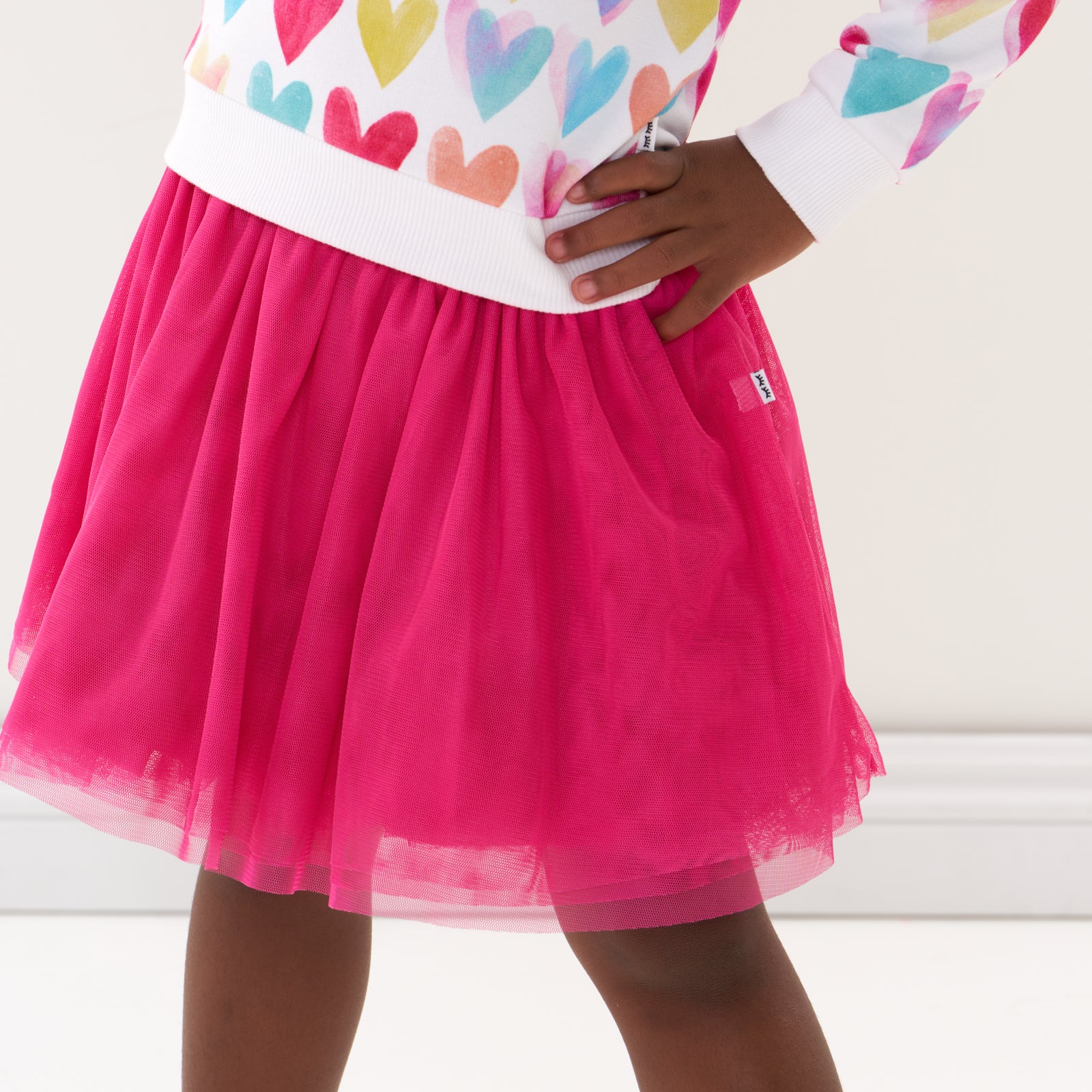 Close up image of a child wearing a Pink Punch tutu skirt