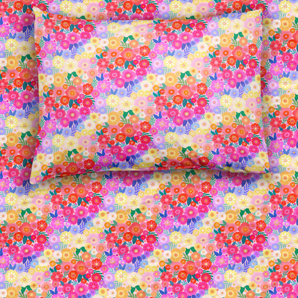 Rainbow Blooms twin sheet set on a mattress and pillow