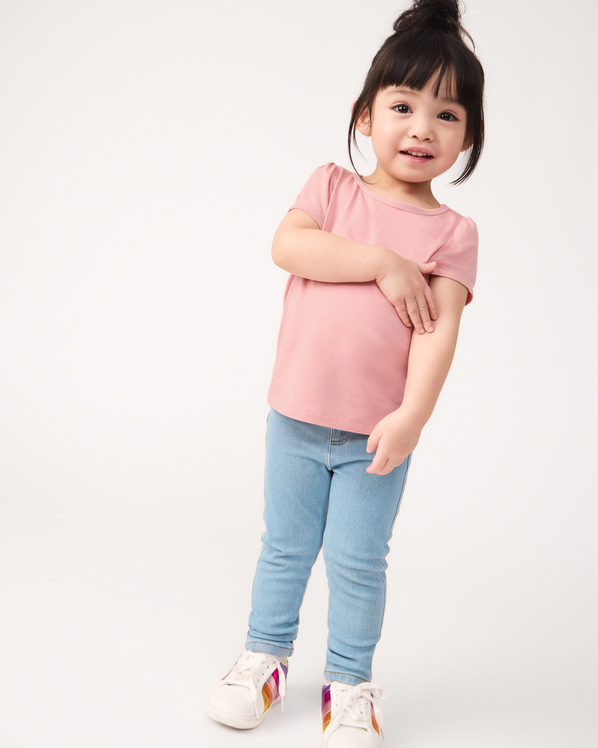 Girl wearing the Mauve Blush Puff Sleeve Tee with denim jeggings