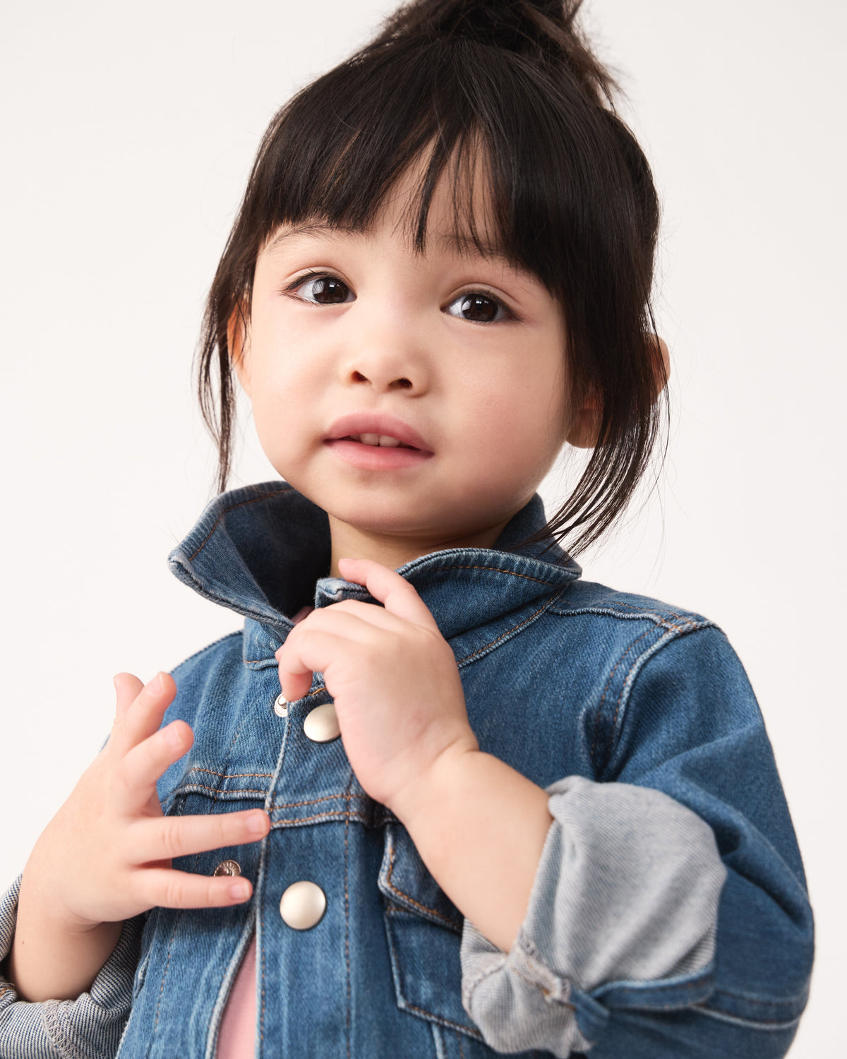 Close up of girl wearing the Midwash Blue Denim Trucker Jacket