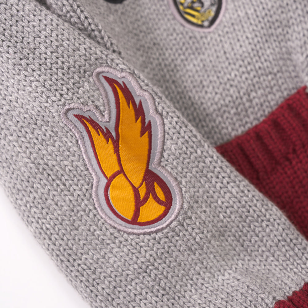 Close up detail shot of a Snitch patch on a Harry Potter Varsity Cardigan