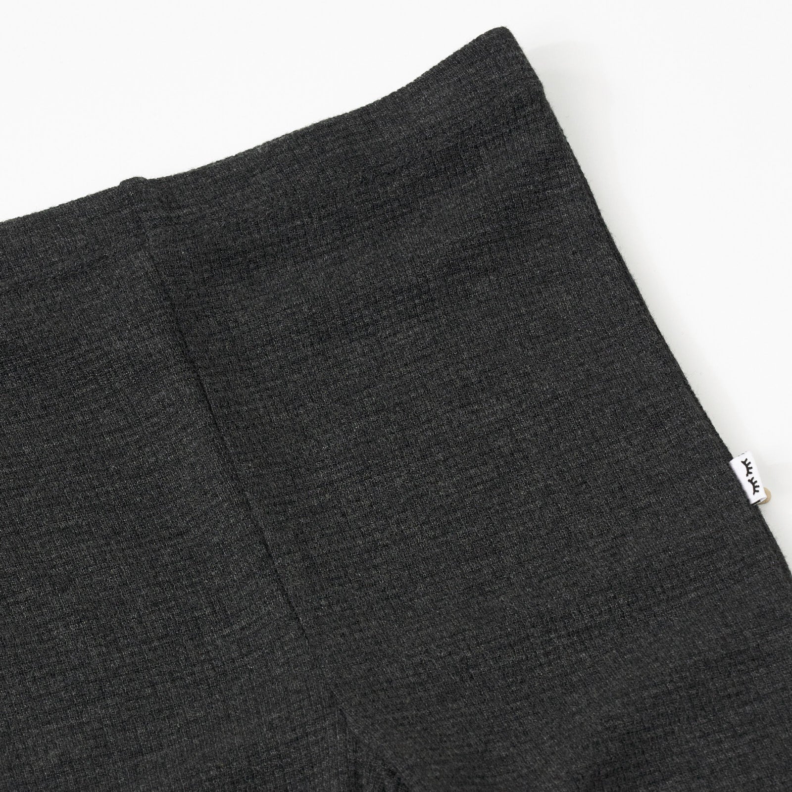 Close up detail shot of a Heather Black Waffle Flare Pant