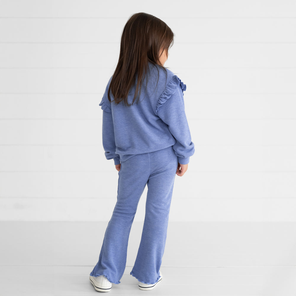 Back view image of a child wearing a Heather Lilac Waffle Flare Pant and Flutter Crewneck