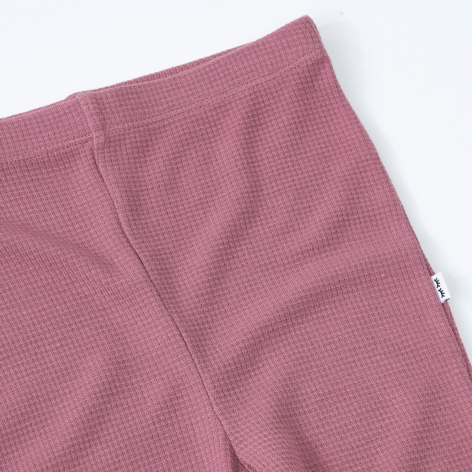 Close up detail shot of a Dusty Plum Waffle Flare Pant