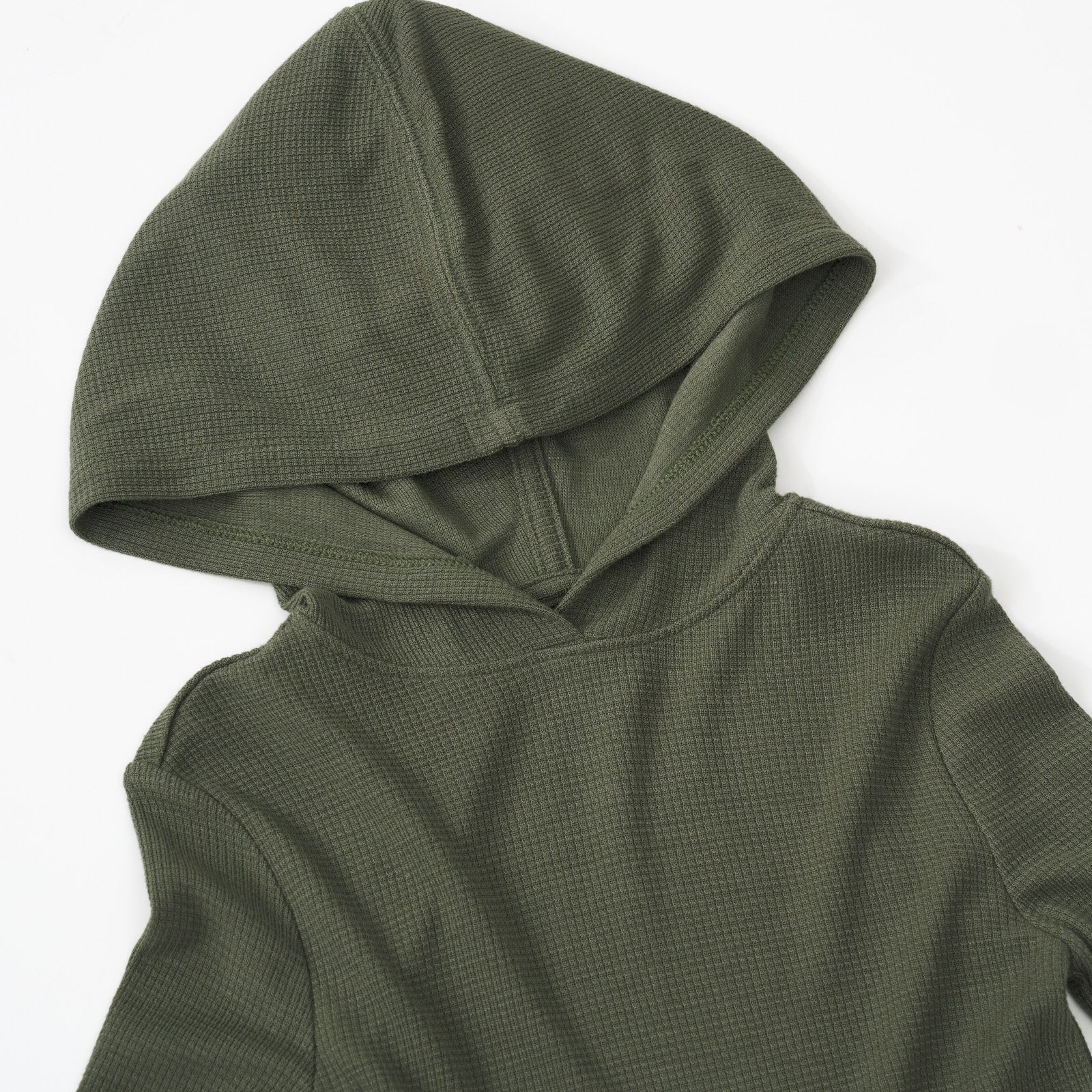 Close up detail shot of an Olive Waffle Peplum Hooded Tee