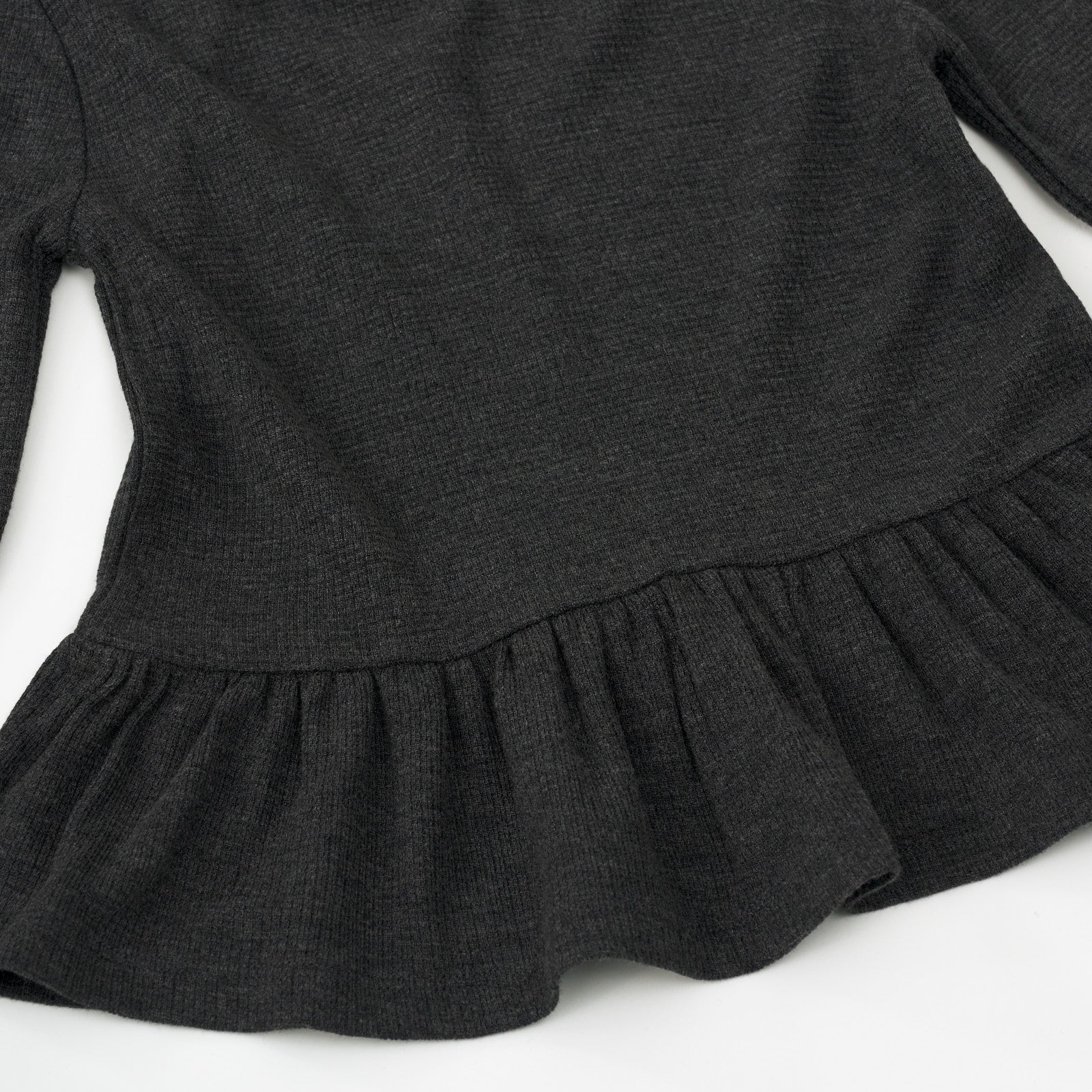 Alternate close up detail shot of a Heather Black Waffle Peplum Hooded Tee