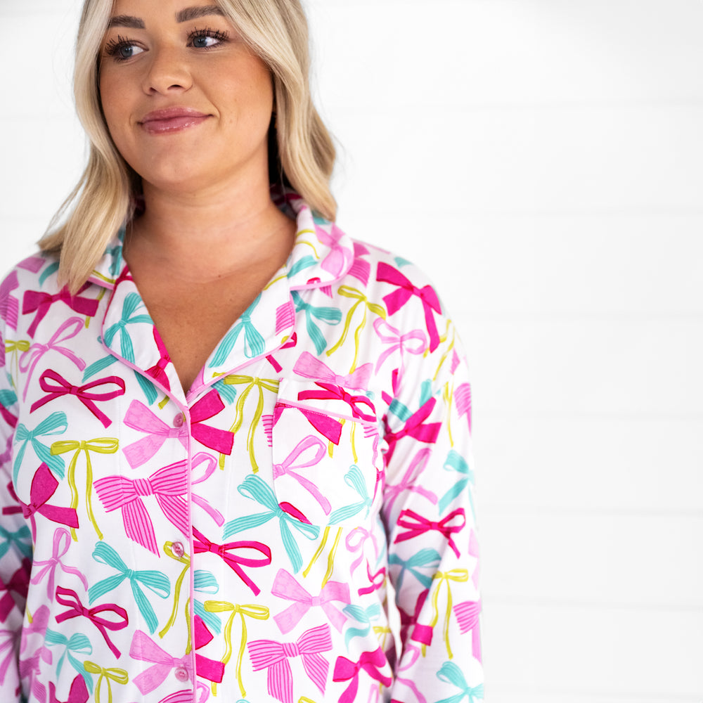 close up image of a woman wearing a Ribbons and Bows sleep shirt detailing the women's shirt pocket