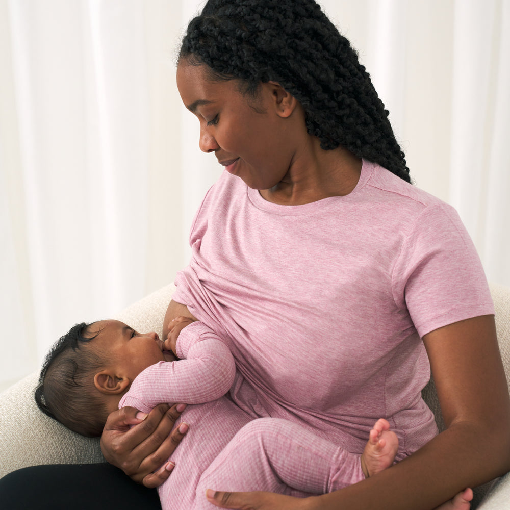 Alternate Image of a woman breastfeeding her child wearing a Heather Mauve women's nursing top. Her child is wearing a matching Heather Mauve zippy