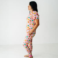 Profile view of a woman wearing Pink Party Pals women's pj top and matching women's pj pants