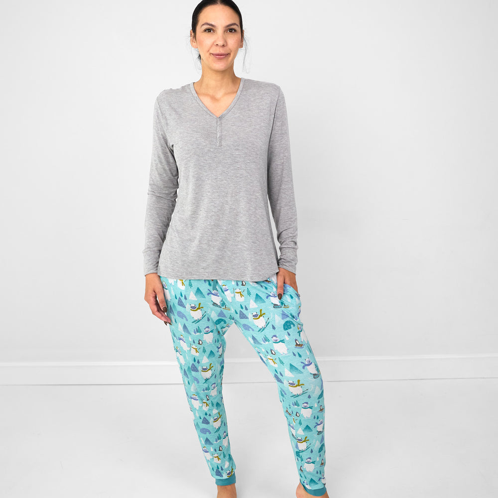 image of a woman wearing a women's Heather Gray pj top and women's Yeti Snow Day pj pants