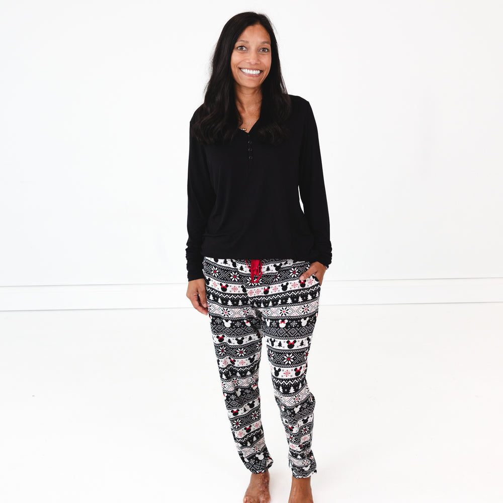 image of a woman wearing women's Mickey Fair Isle pj pants and women's solid black pj top