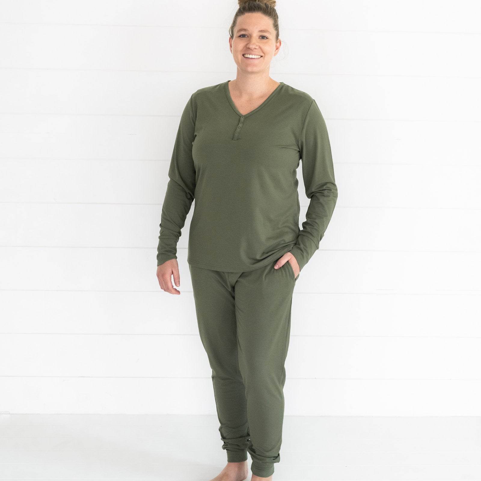 Image of a woman wearing a women's Cozy Olive pj top and matching pj pants