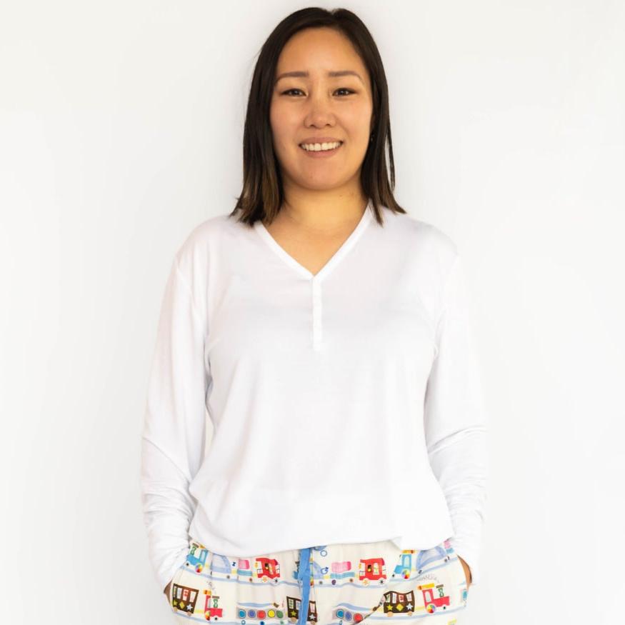 woman wearing a women's bright white pj top paired with Education Express printed women's pj pants