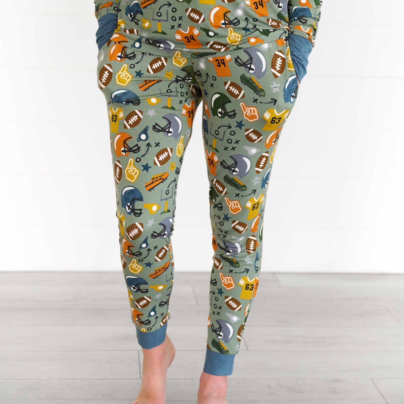 Close up image of the touchdown-time-womens-pajama-pants, while model has hands in the pockets