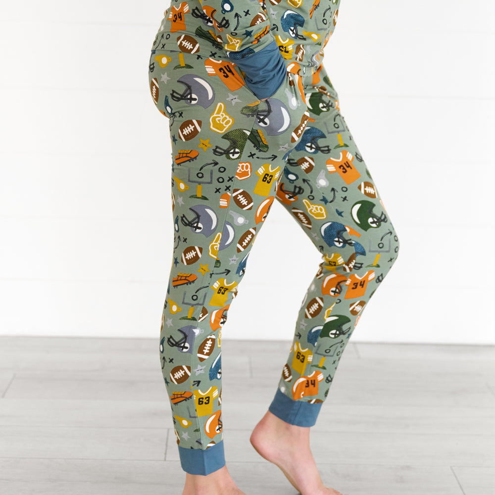 Side view image of the touchdown-time-womens-pajama-pants, while model has hands in the pockets