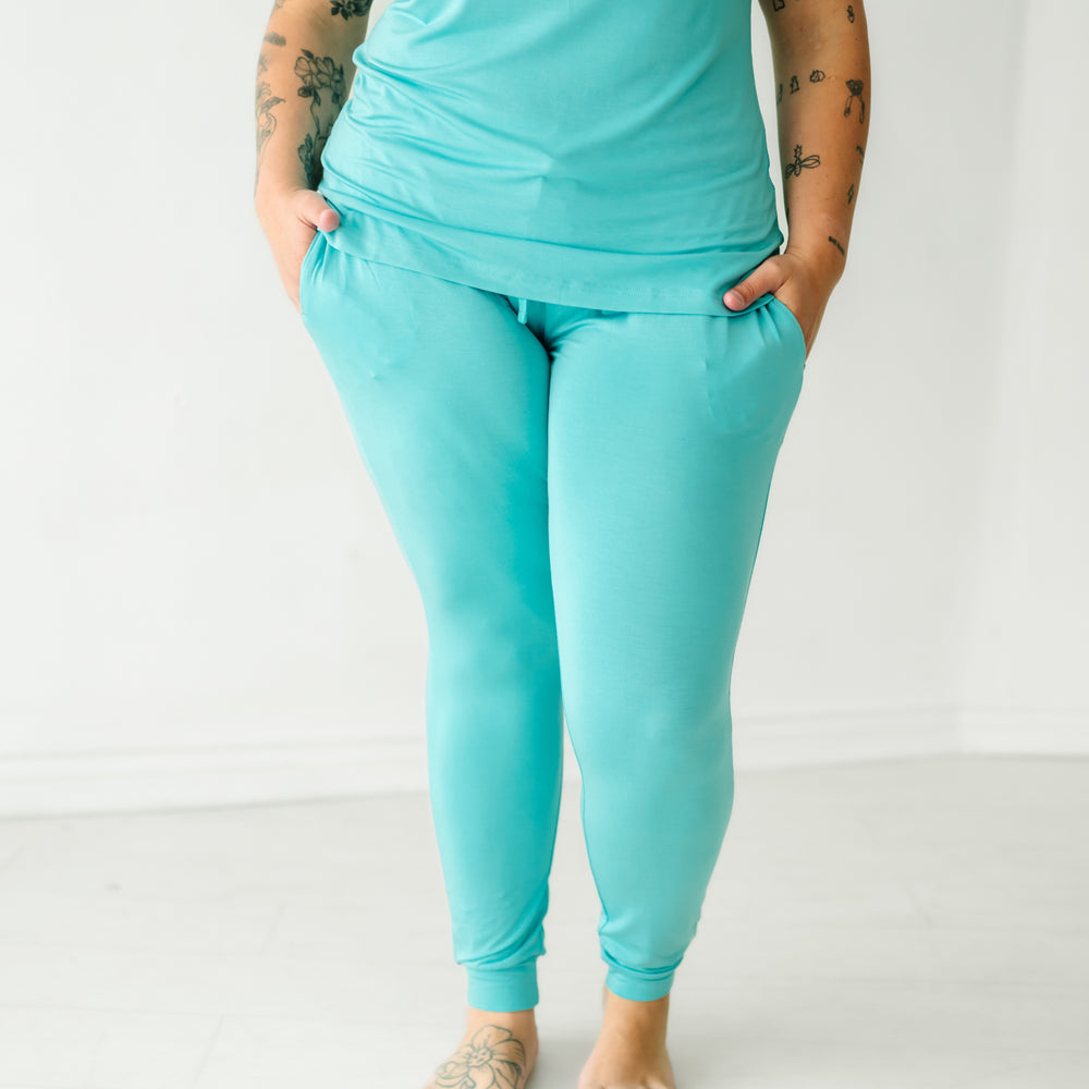 Close up image of a woman wearing Glacier Turquoise women's pajama pants