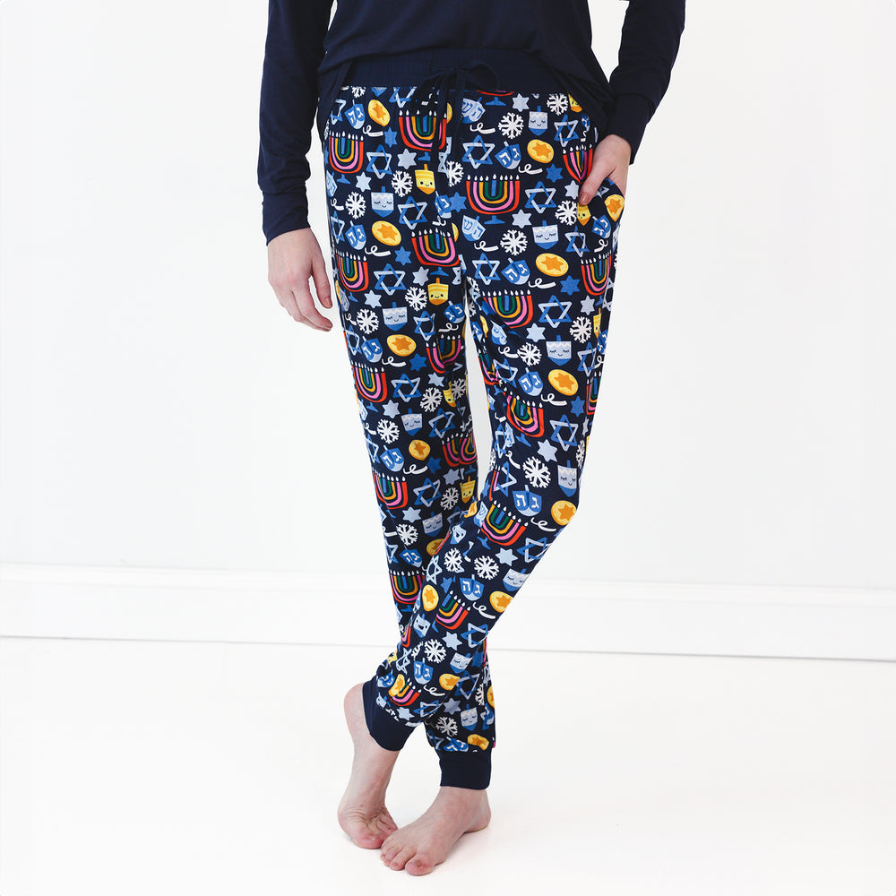 Close up image of a woman wearing Playful Dreidels Women's Pajama Pants and Classic Navy Women's Pajama Top