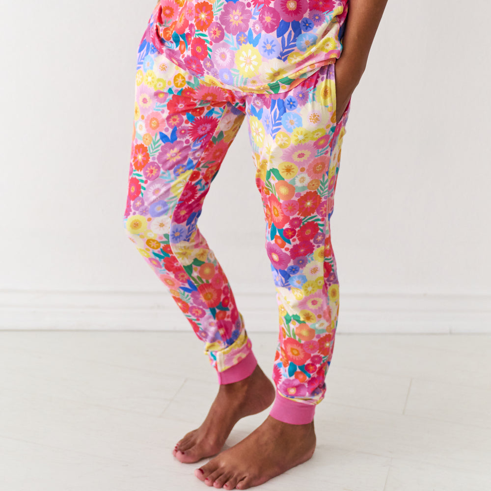 Close up image of a woman wearing Rainbow Blooms women's pajama pants and matching pajama top