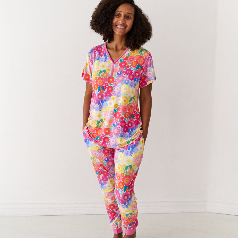 Woman wearing Rainbow Blooms women's pajama pants and matching pajama top