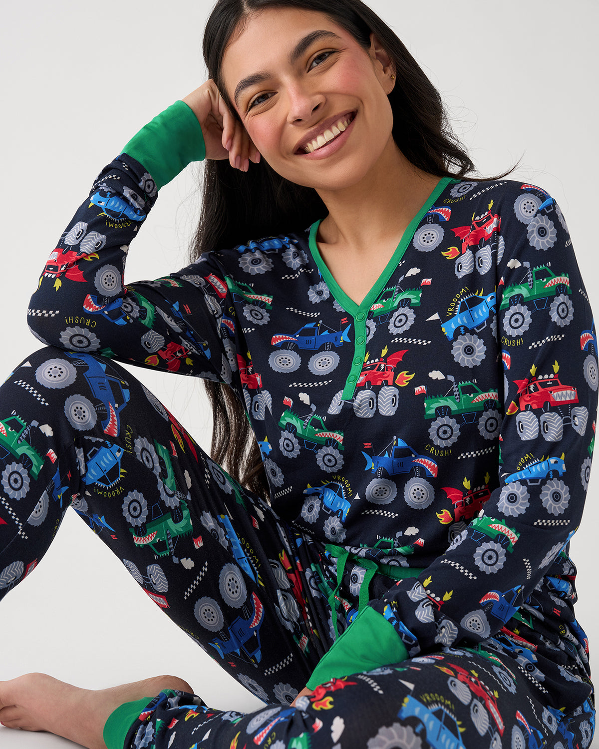 Sitting woman wearing the Monster Truck Madness Women's Pajama Top and Pants