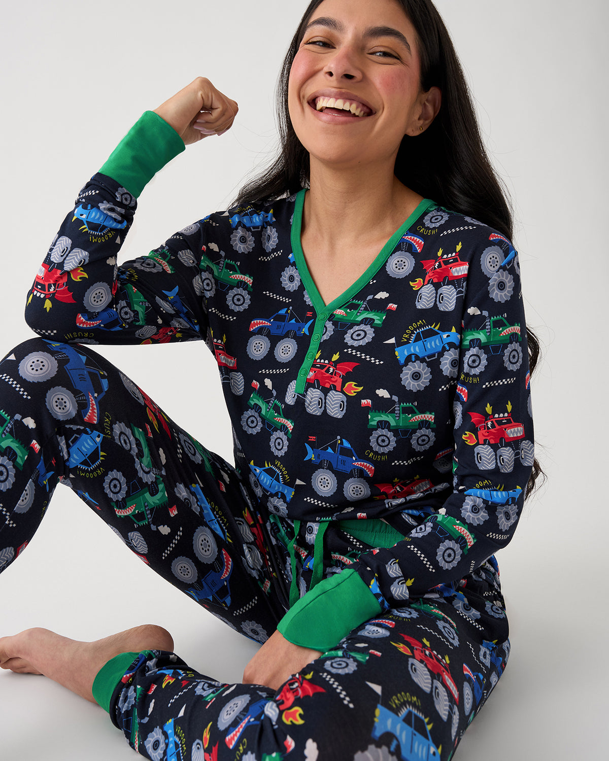 Sitting woman wearing the Monster Truck Madness Women's Pajama Pants and Top