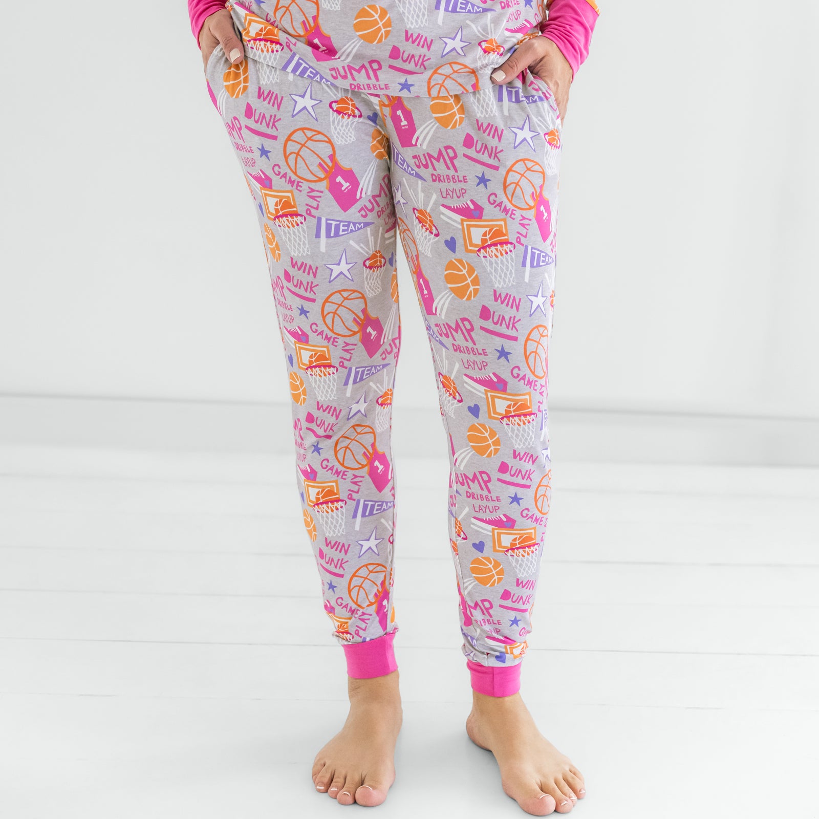 Front view of woman standing in the Pink Slam Dunk pajama pants