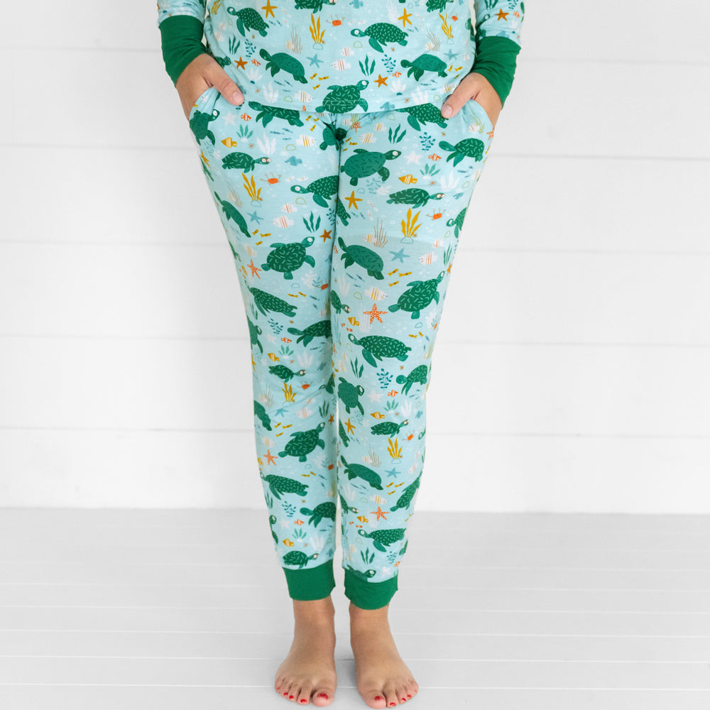 Close up image of a woman wearing Sea turtle Friends women's pj pants