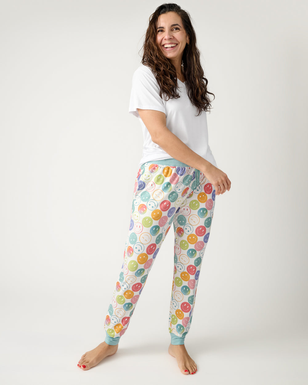 Woman wearing the Positive Vibes Women's Pajama Pants with a white PJ top