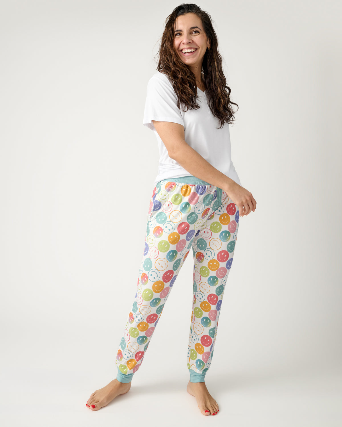 Woman wearing the Positive Vibes Women's Pajama Pants with a white PJ top