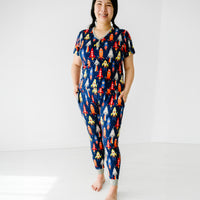 Woman posing wearing women's Navy Space Explorer pajama pants paired with matching women's pajama top