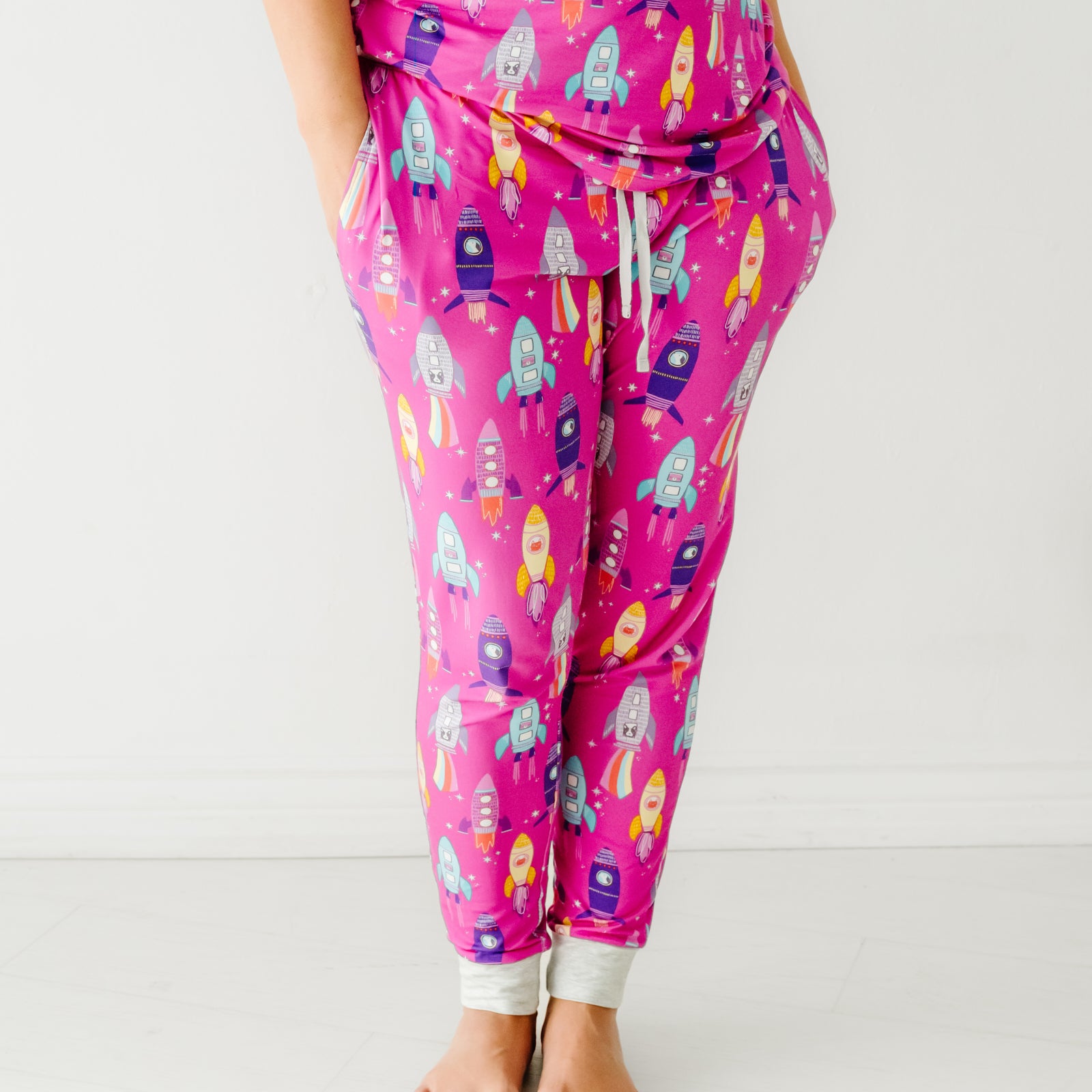 Close up image of a woman wearing a Pink Space Explorer women's pajama pants