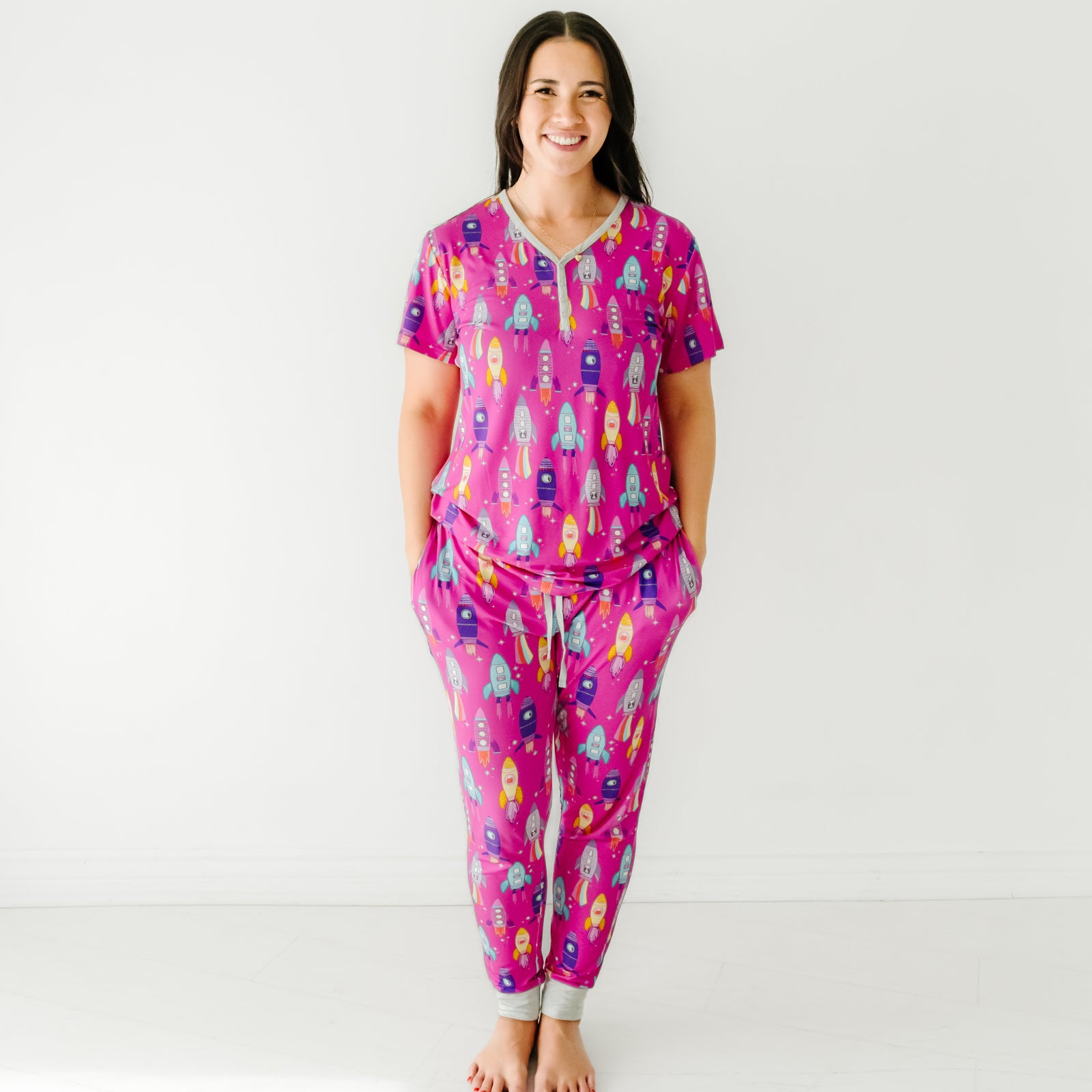 Woman wearing Pink Space Explorer women's pajama top and matching women's pajama pants