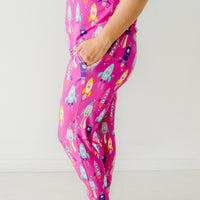 Close up profile image of a woman wearing women's Pink Space Explorer pajama pants