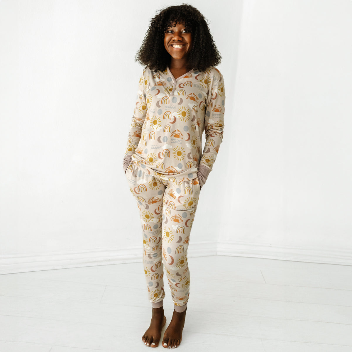 Woman wearing a Desert Sunrise women's pajama top paired with matching women's pajama pants