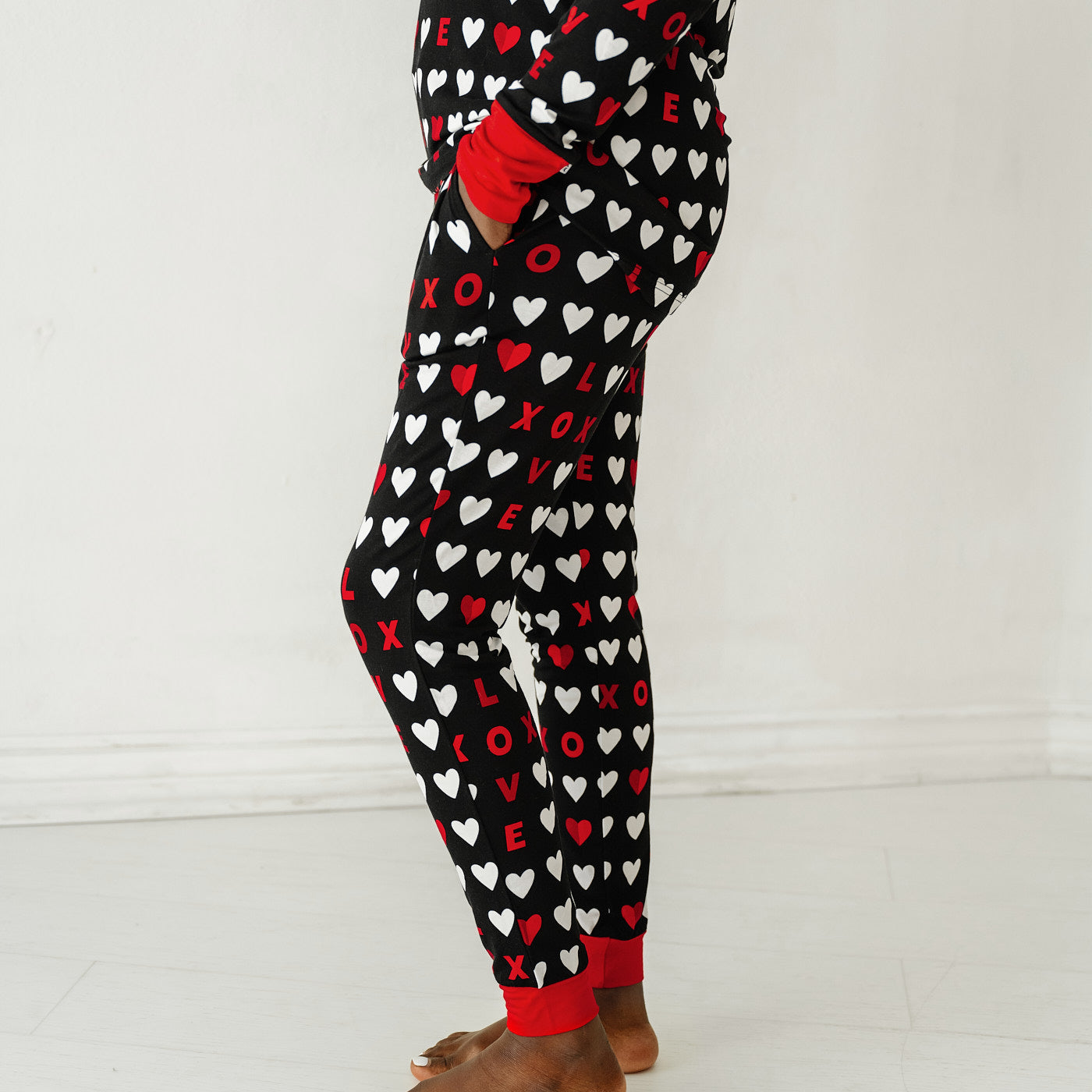 Close up profile image of a woman wearing Black XOXO women's pajama pants