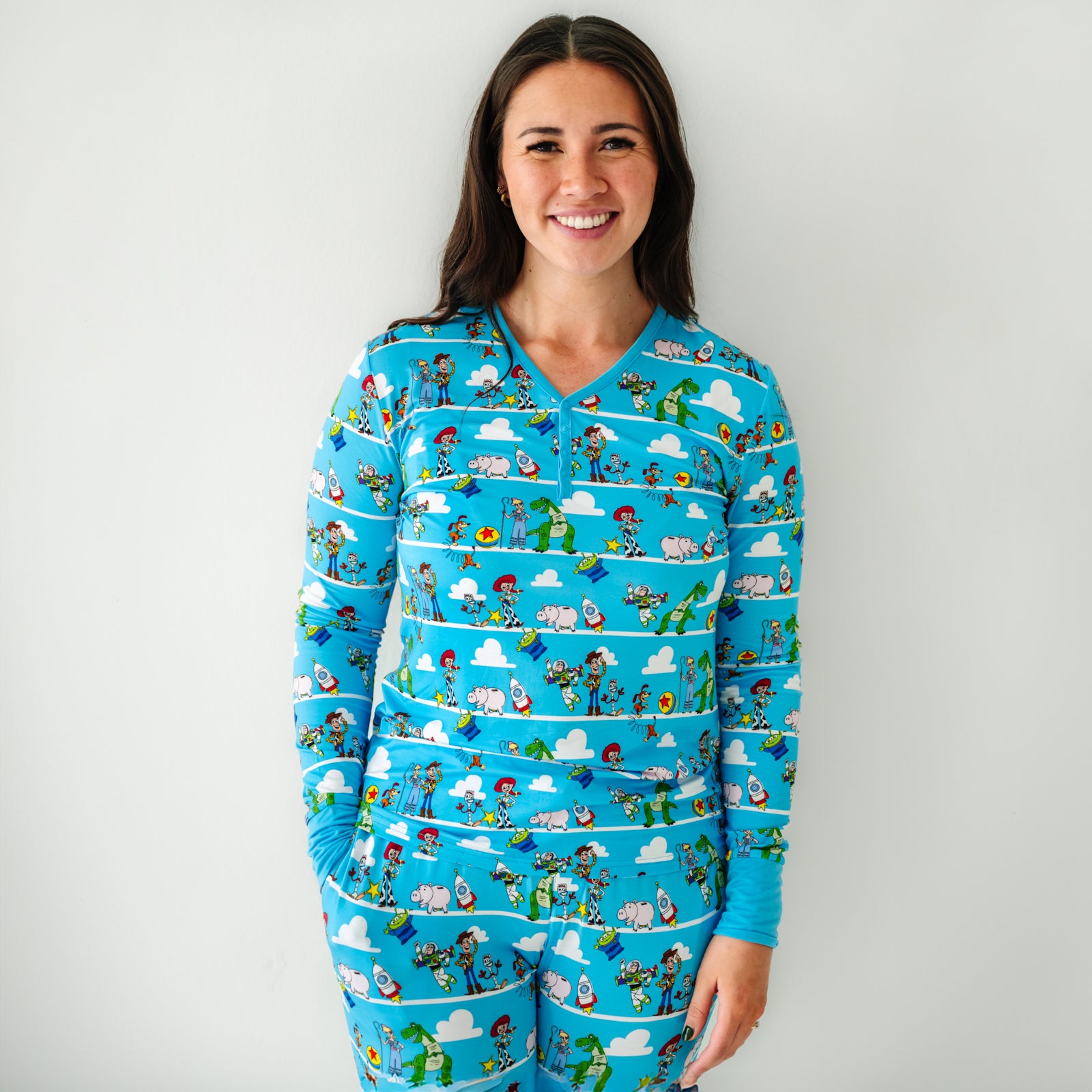 Woman wearing a Disney Pixar Toy Story Pals women's pajama top and matching pajama pants