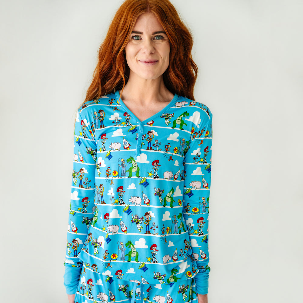 Click to see full screen - Close up image of a woman wearing a Disney Pixar Toy Story Pals women's pajama top and matching pajama pants