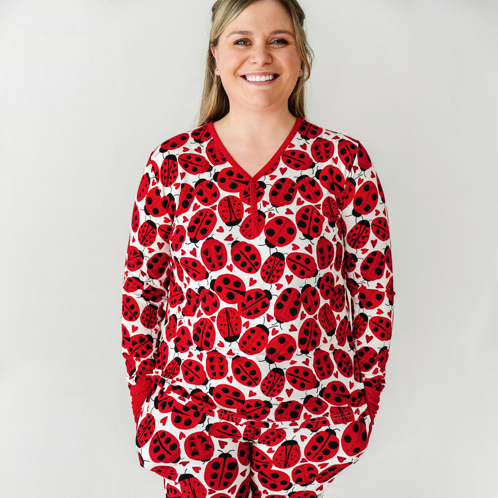 Click to see full screen - Alternate close up image of a woman wearing a Love Bug printed women's pajama top and matching pajama pants