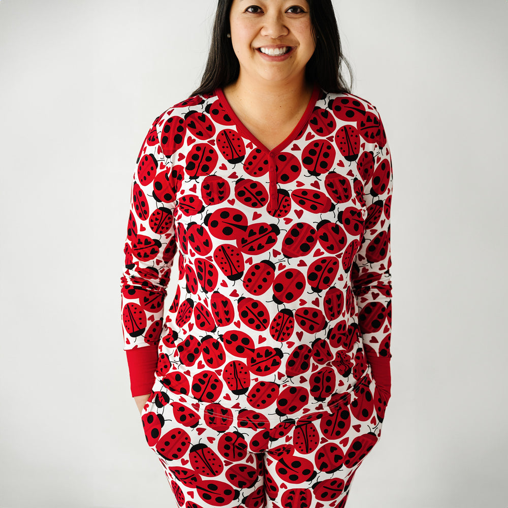 Click to see full screen - Close up image of a woman wearing a Love Bug printed women's pajama top and matching pajama pants