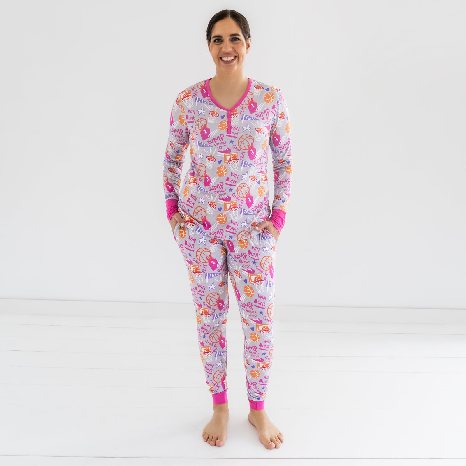 Woman standing in the Pink Slam Dunk pajama pants and matching top