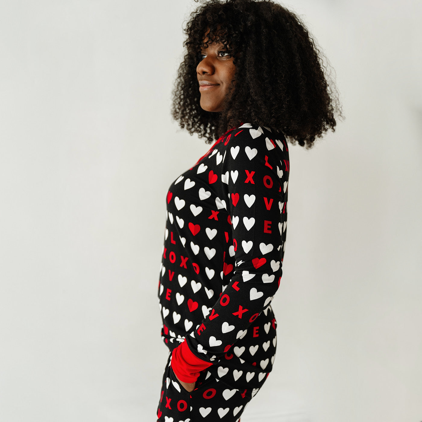 Close up profile image of a woman wearing Black XOXO women's pajama top